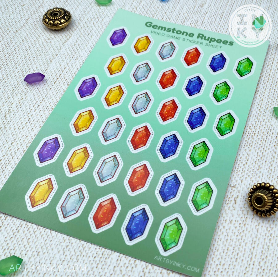 Video game rupees sticker sheet on a cotton background at a different angle to show the materials and size.