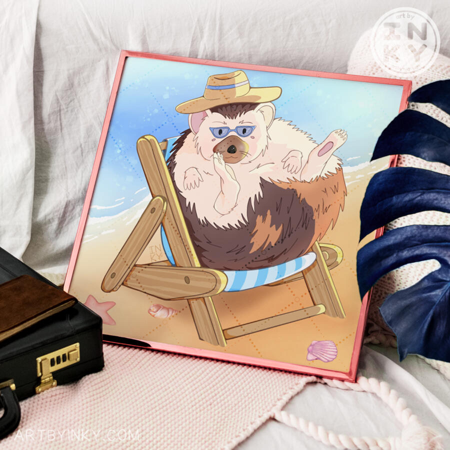 Art print of an illustrated hedgehog on a beach in a pink frame against linens next to a plant and briefcase.